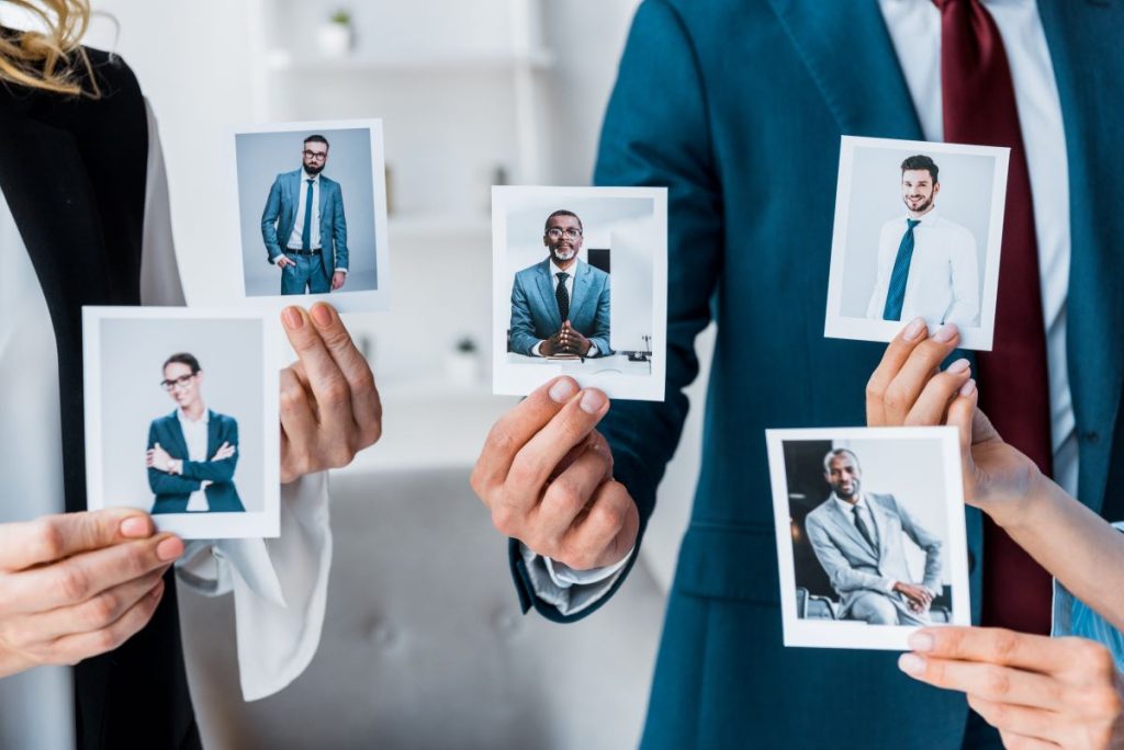 cropped view of recruiters touching photos while s 2023 11 27 04 49 55 utc