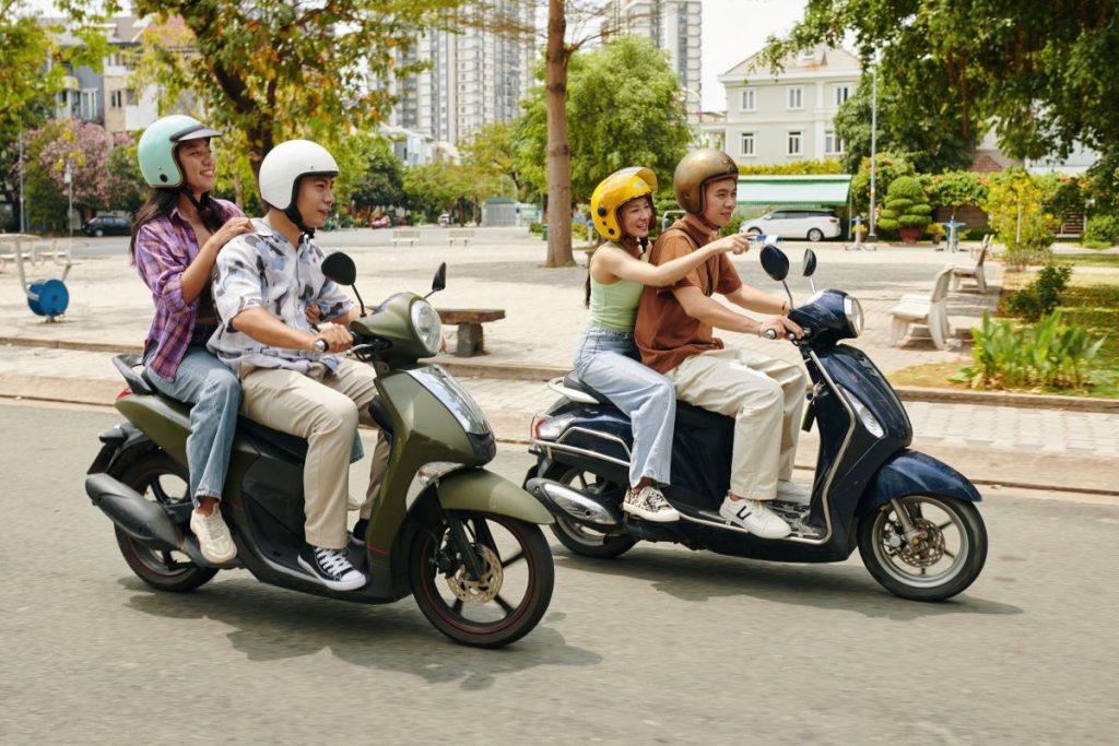 friends pointing and smiling while riding scooters 2024 05 31 19 02 36 utc